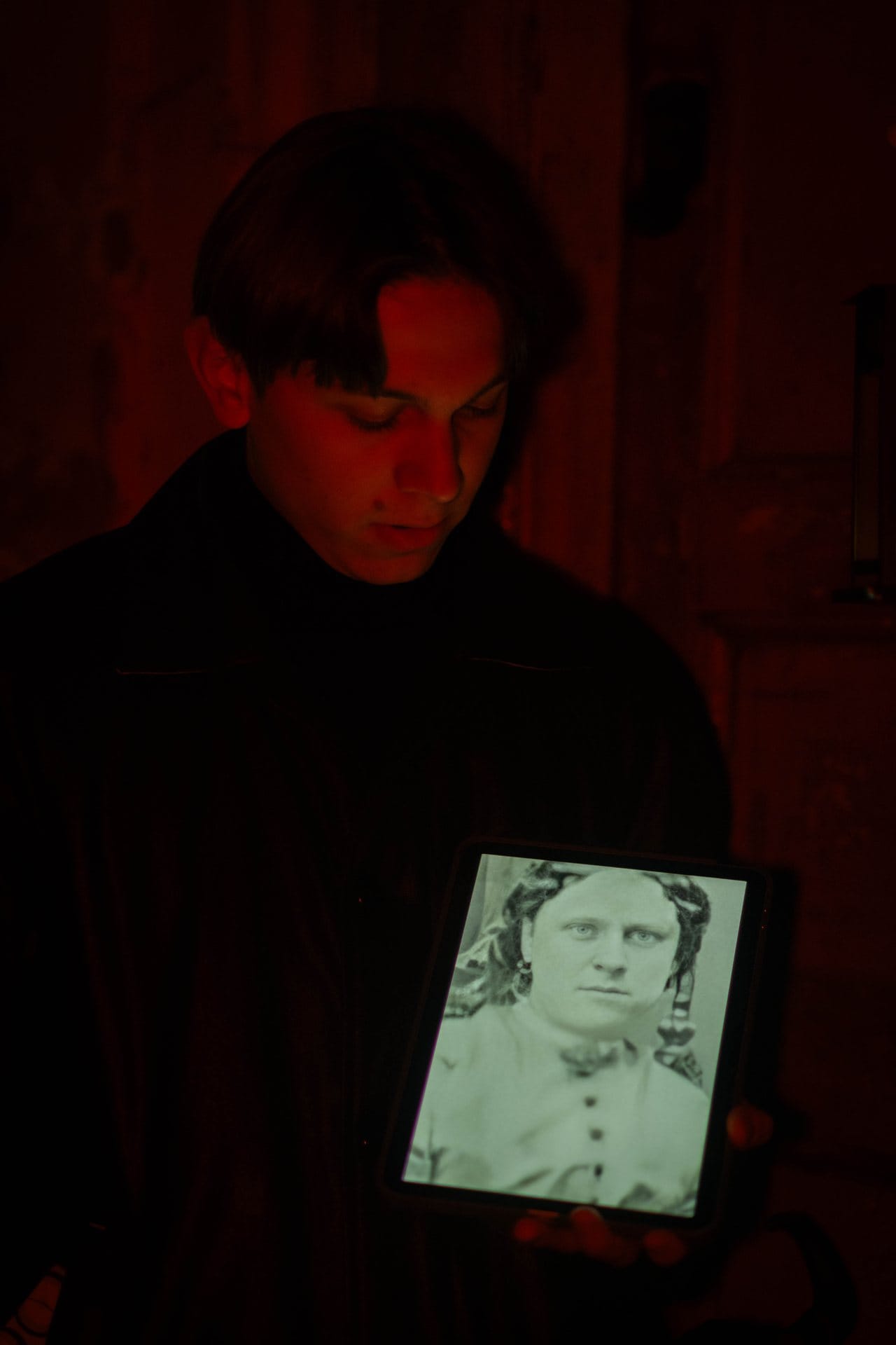 Jack the Ripper tour guide presenting historical victim photograph during Whitechapel walking tour