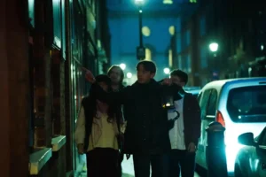 Jack the Ripper walking tour group exploring London night streets in Whitechapel